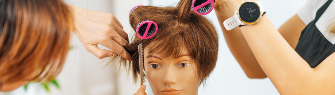 students doing hair on a mannequin 
