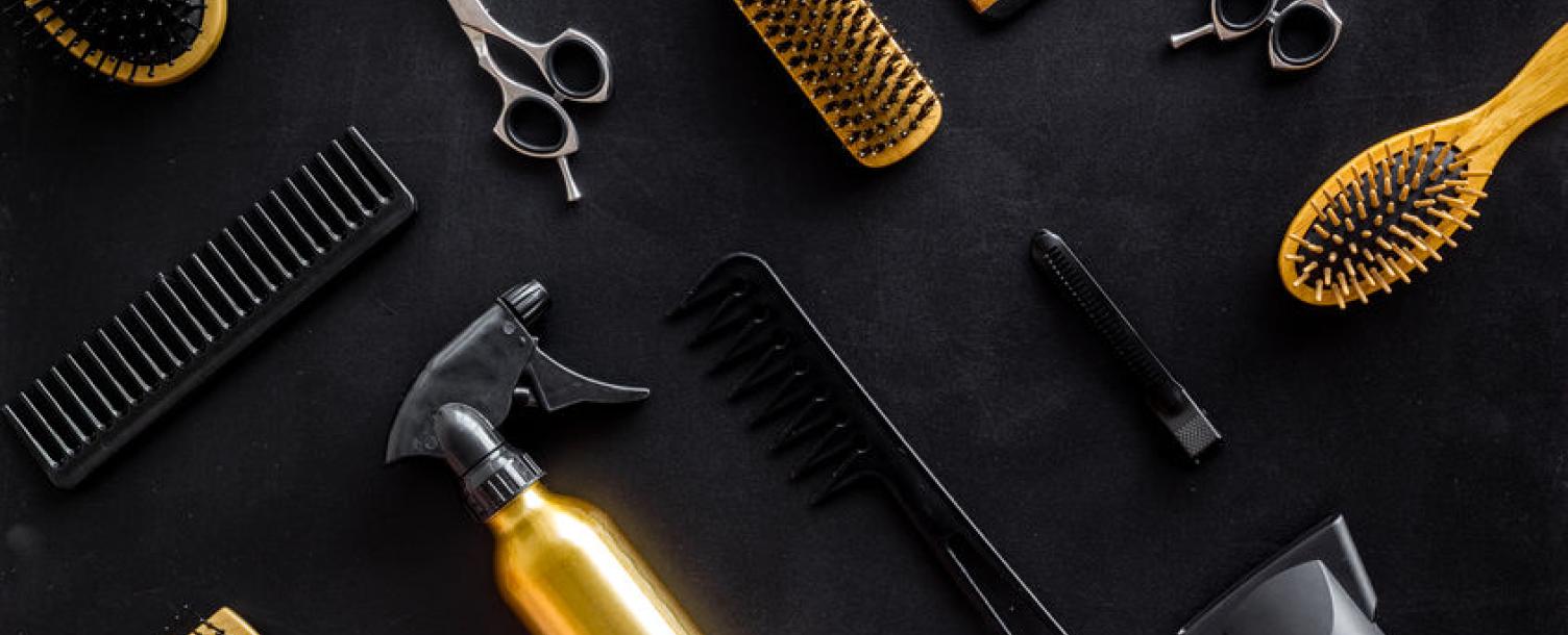 Combs, scissors and brushes on a table