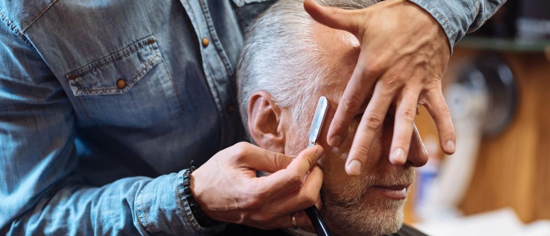 Barber using a straight edge